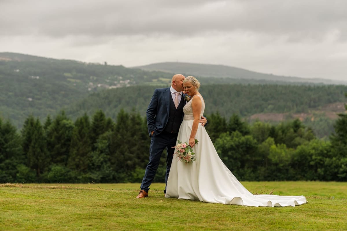 wedding couple posed against the Tamar Valley backdrop